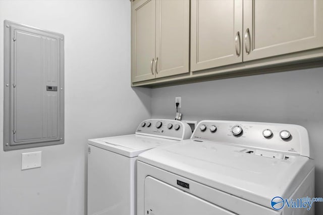 laundry area with electric panel, cabinets, and washing machine and clothes dryer