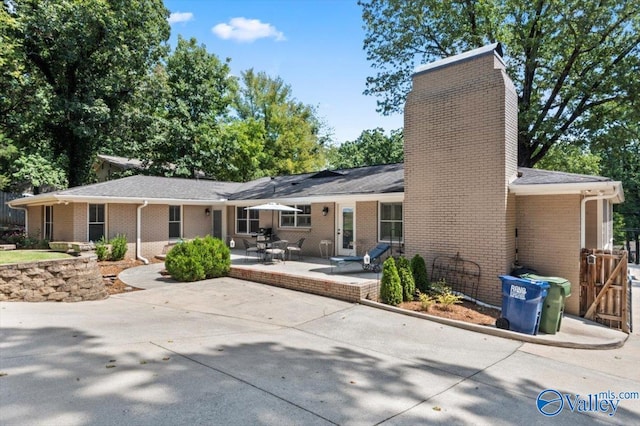 back of property with a patio