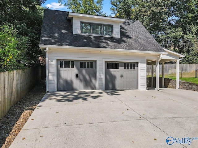 detached garage featuring fence