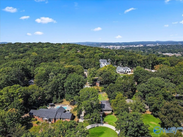 drone / aerial view featuring a wooded view