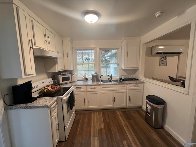 kitchen with light stone counters, white cabinetry, dark wood-type flooring, sink, and white appliances