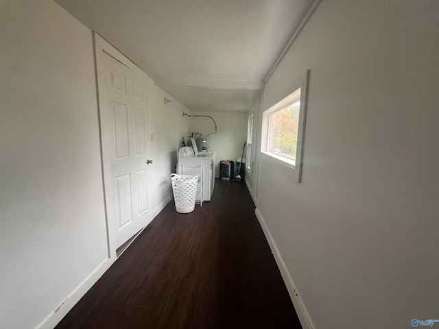 hall with independent washer and dryer and dark wood-type flooring