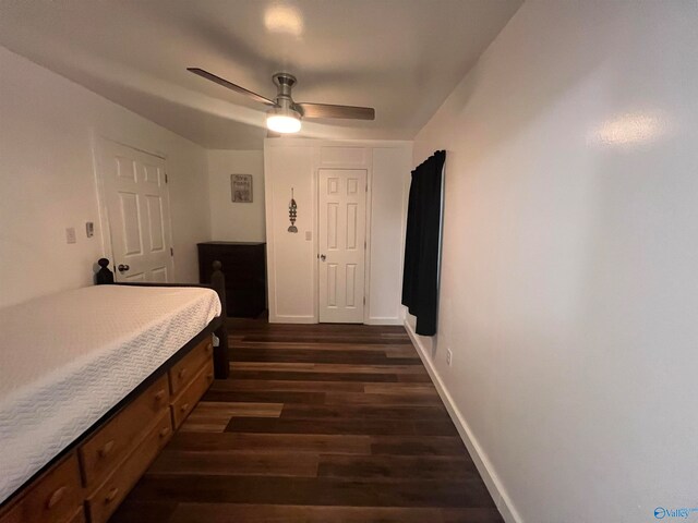 bedroom with dark hardwood / wood-style flooring and ceiling fan