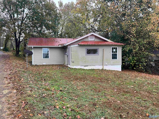 rear view of property featuring a yard