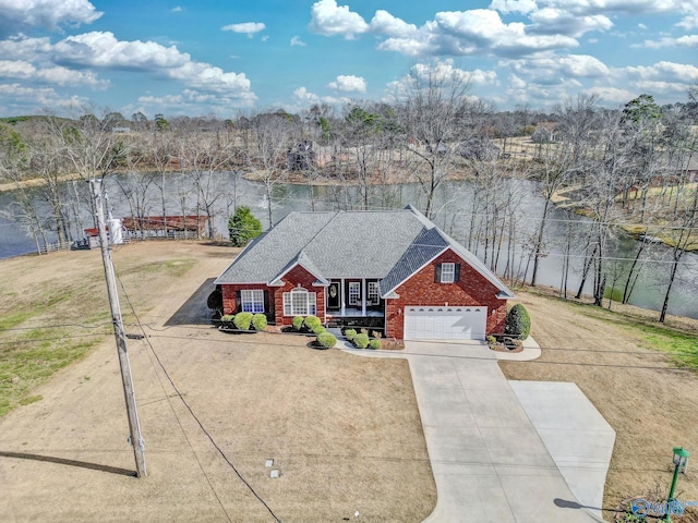 view of front facade featuring brick siding, driveway, and roof with shingles