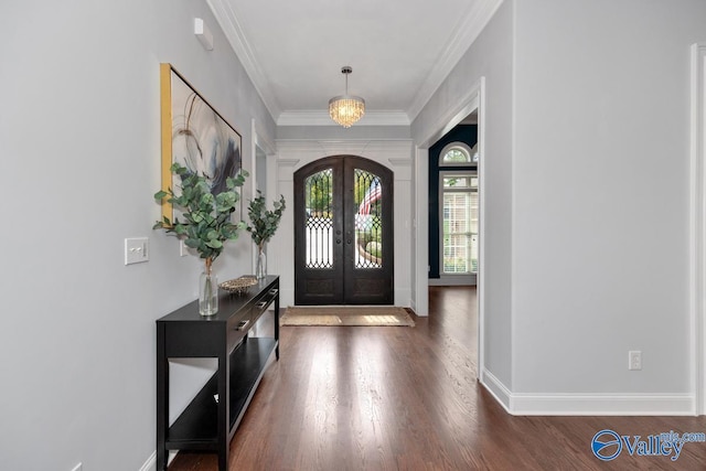 foyer featuring baseboards, ornamental molding, dark wood-style flooring, and french doors