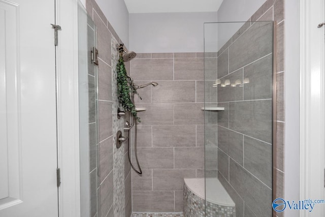 bathroom with tiled shower