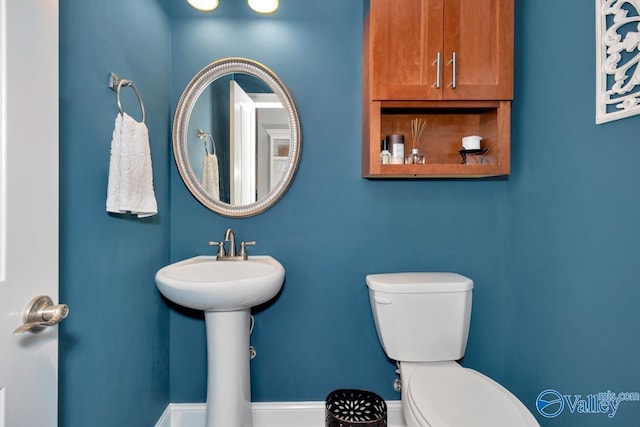 half bathroom with a sink and toilet