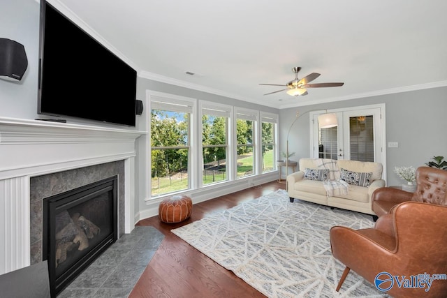 living area with french doors, ornamental molding, a high end fireplace, and visible vents