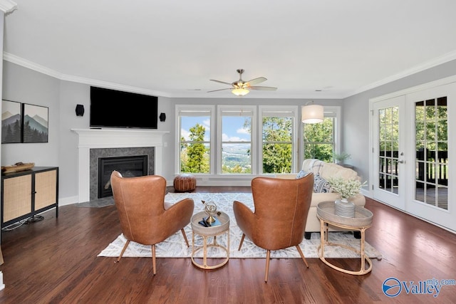 living room featuring a premium fireplace, dark wood finished floors, and crown molding