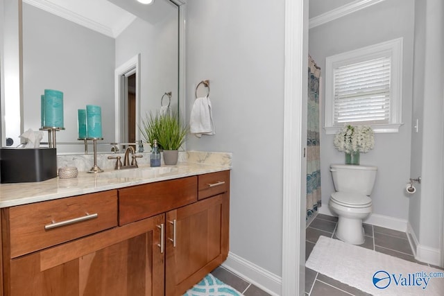 bathroom with baseboards, toilet, ornamental molding, tile patterned flooring, and vanity