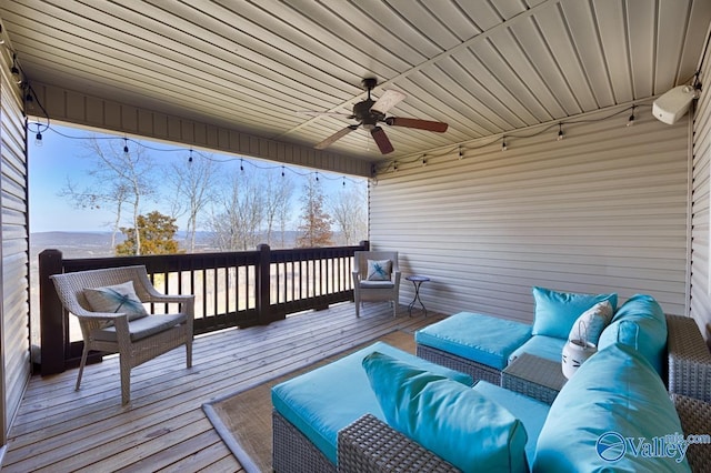 wooden terrace featuring an outdoor living space and a ceiling fan