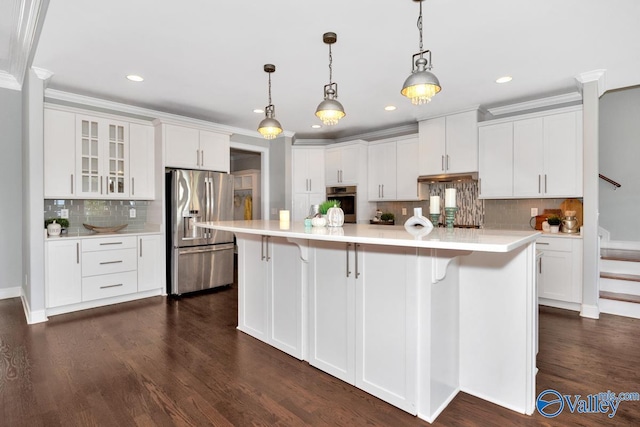 kitchen featuring white cabinets, a large island, glass insert cabinets, appliances with stainless steel finishes, and light countertops