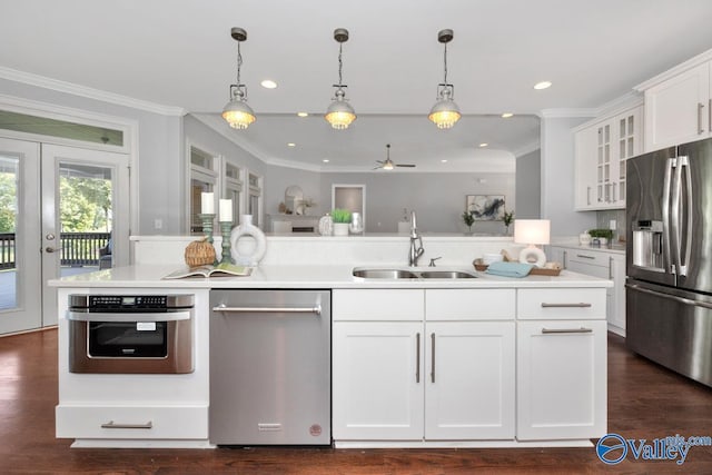 kitchen featuring white cabinetry, appliances with stainless steel finishes, light countertops, and a sink