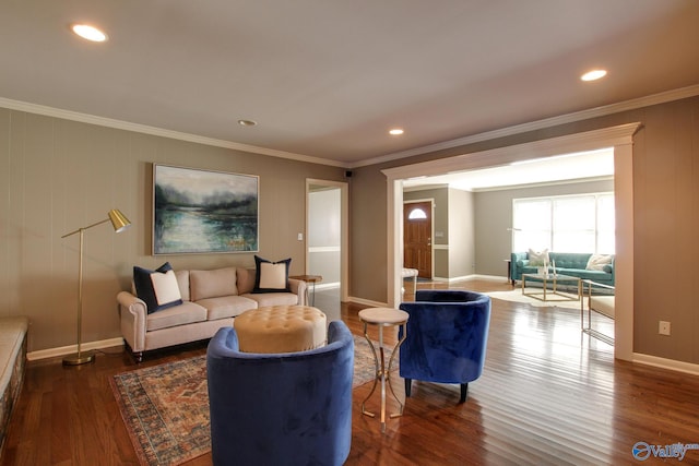 living area featuring ornamental molding, wood finished floors, and baseboards