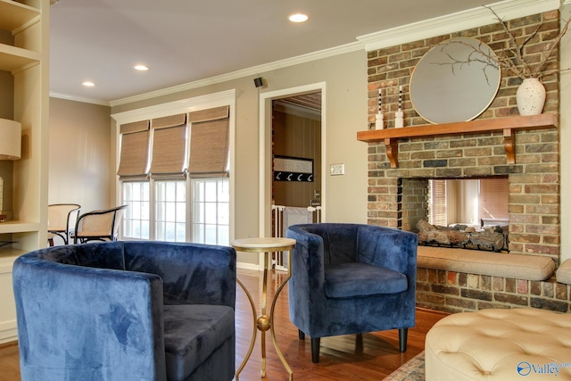 living room featuring ornamental molding, a fireplace, wood finished floors, and recessed lighting