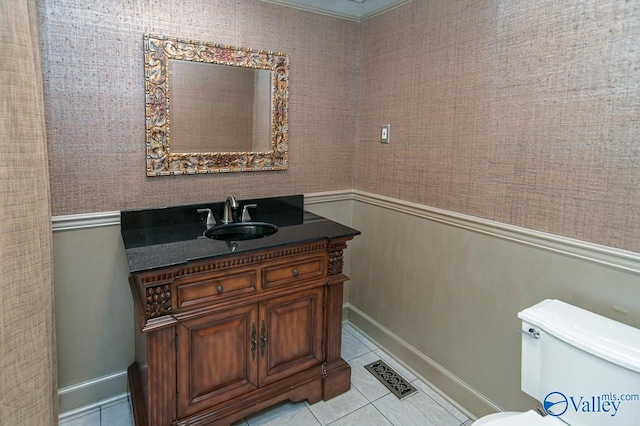 bathroom featuring toilet, vanity, visible vents, and tile patterned floors