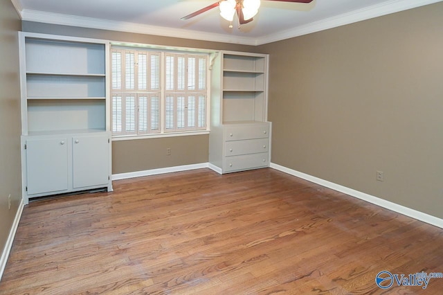 unfurnished bedroom featuring baseboards, wood finished floors, a ceiling fan, and crown molding