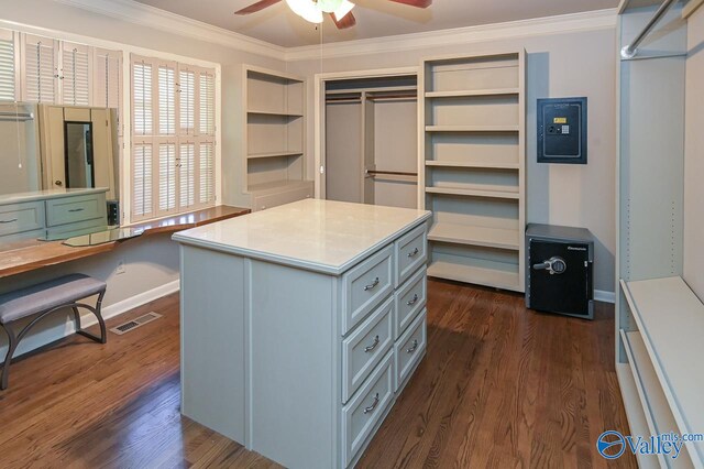 spacious closet featuring ceiling fan, visible vents, and dark wood-type flooring