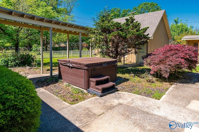 view of yard with a patio area, a hot tub, and fence