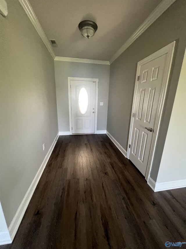 foyer entrance featuring dark hardwood / wood-style flooring and ornamental molding