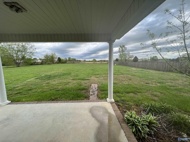 view of yard with a rural view and a patio area