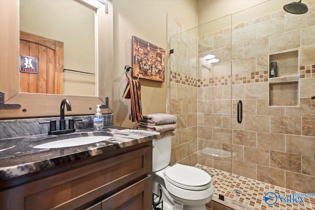 full bathroom with a shower stall, toilet, and vanity