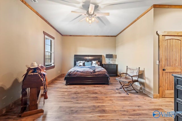 bedroom featuring crown molding, baseboards, and wood finished floors