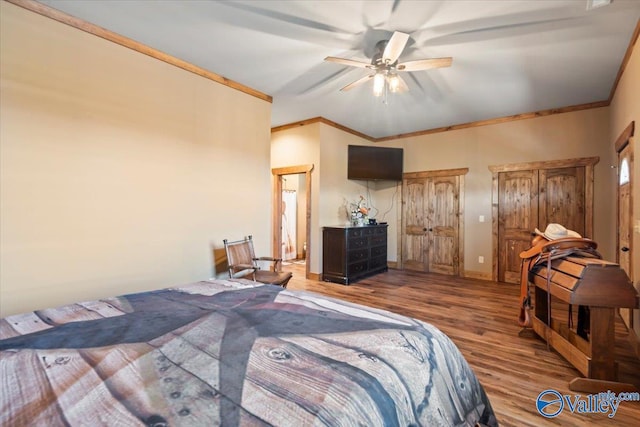 bedroom featuring ornamental molding, wood finished floors, a ceiling fan, and baseboards