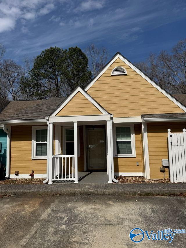 view of front of home featuring a porch and a shingled roof