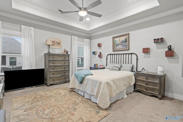 bedroom with ceiling fan, a raised ceiling, light colored carpet, and ornamental molding