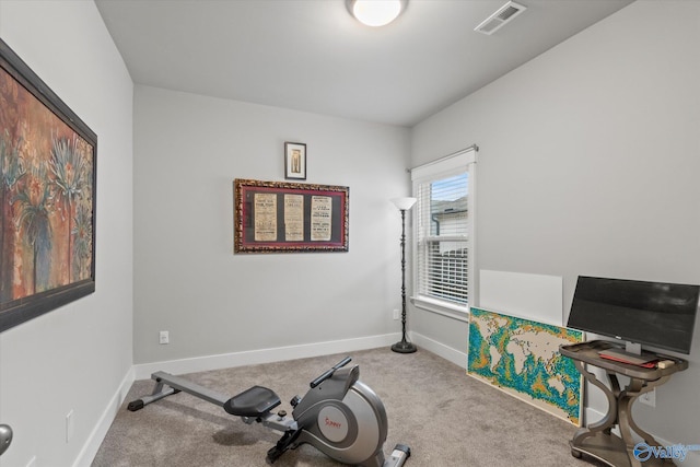 exercise room with light colored carpet