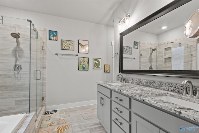 bathroom with vanity and a shower with door