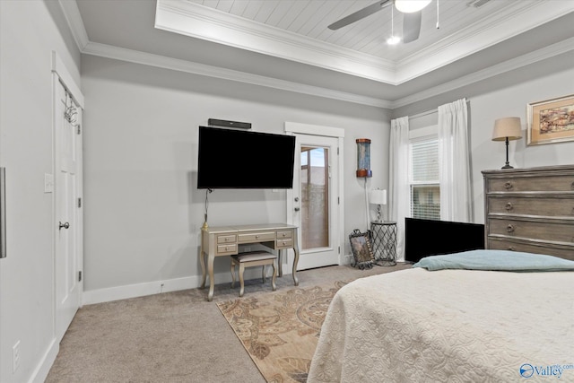 carpeted bedroom with a raised ceiling, ceiling fan, and ornamental molding