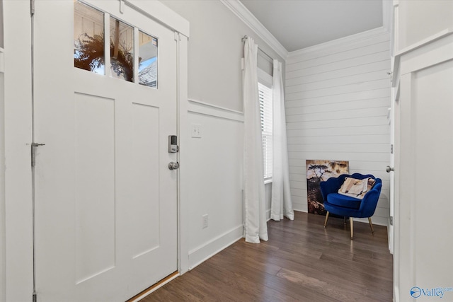 foyer entrance featuring ornamental molding and dark wood-type flooring