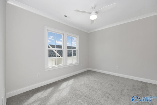 carpeted spare room with ornamental molding and ceiling fan