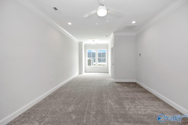 spare room featuring crown molding, ceiling fan, and carpet