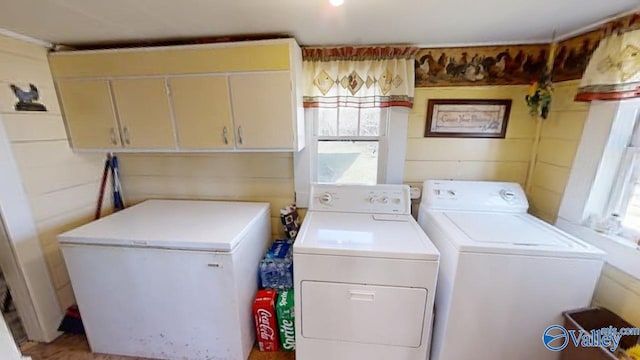 washroom with cabinets and separate washer and dryer