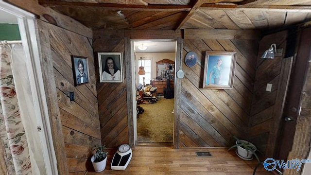 hallway with wood ceiling, wood-type flooring, and wood walls