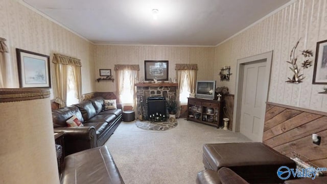 carpeted living room with crown molding and a stone fireplace