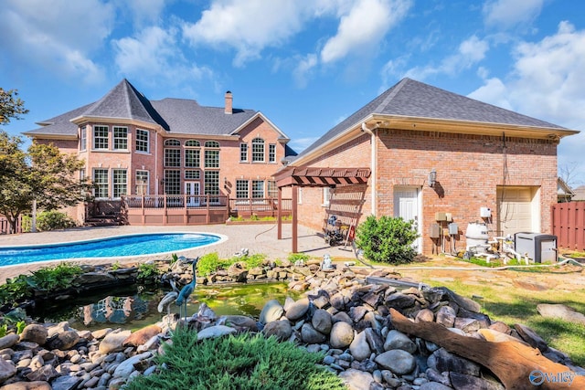 back of property featuring a patio and a pergola