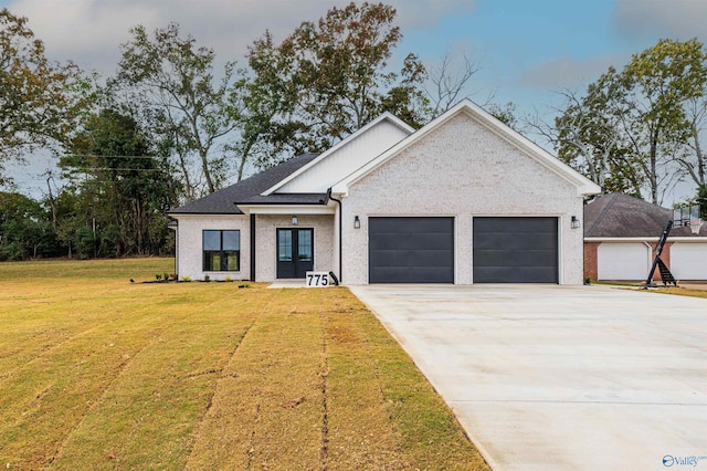 view of front of home with a garage and a front lawn