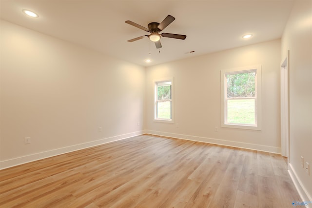 unfurnished room featuring plenty of natural light, light hardwood / wood-style floors, and ceiling fan