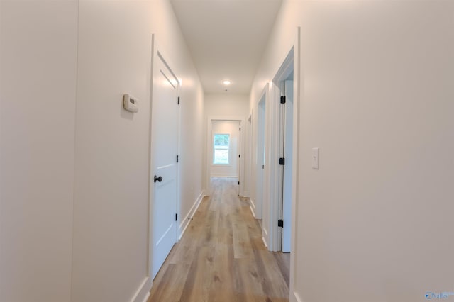 corridor with light hardwood / wood-style floors