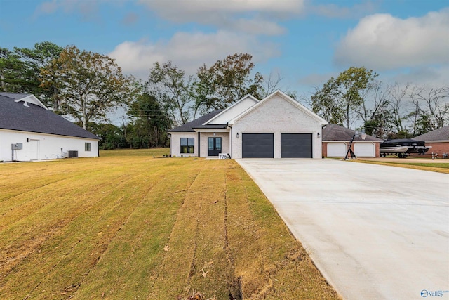 view of front of home featuring a garage and a front lawn