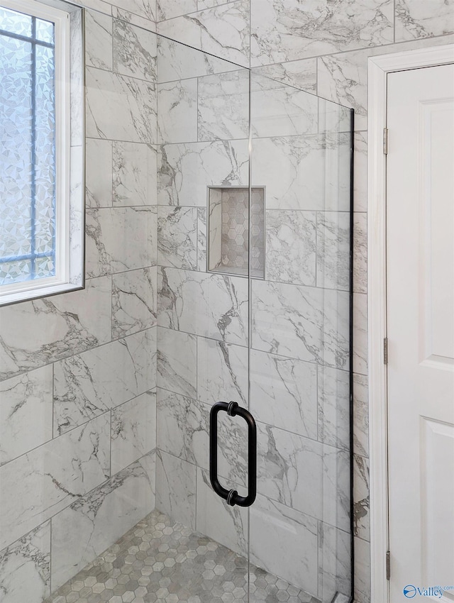 interior details featuring an enclosed shower