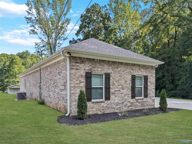 view of property exterior featuring central AC unit and a lawn