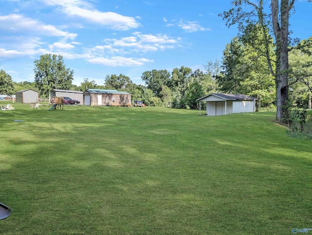 view of yard featuring a carport and a shed