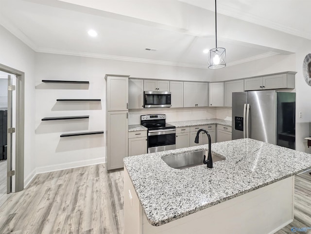 kitchen featuring light stone counters, appliances with stainless steel finishes, decorative light fixtures, and sink