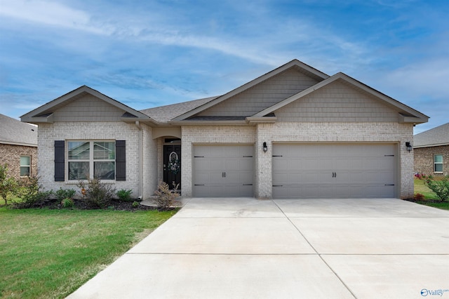 view of front of property featuring an attached garage, driveway, a front yard, and brick siding